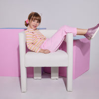 Girl/Tween cropped velour pants in the light pink velour shade. Pants feature a soft velour material, with pockets in the front, and an elastic waistband for a comfy fit. Model can be seen wearing a knit top with angel sleeves in a pastel stripe pattern to complete the look.