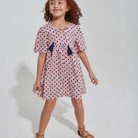 tween girls pink and navy geo print dress with scalloped sleeves and navy tassels