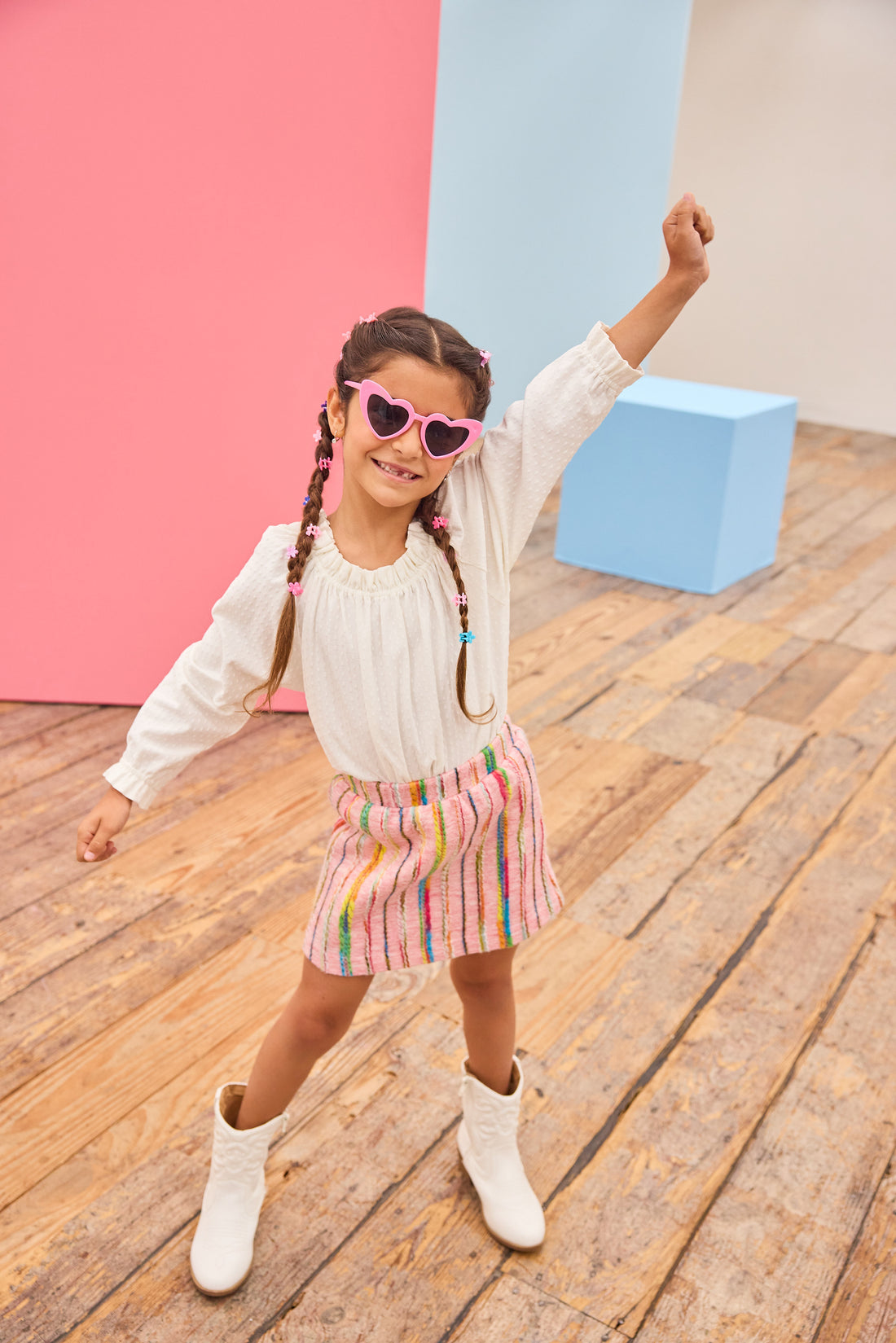 Model can be seen wearing a white pointelle knit top paired back with a skort in multi-color wool. Skort features an elastic waistband and built in shorts for a secure but comfy fit.