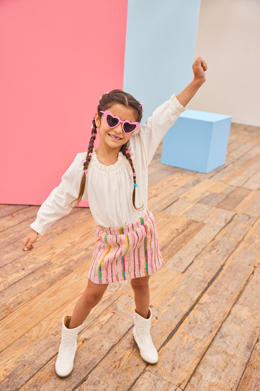 Model can be seen wearing a white pointelle knit top paired back with a skort in multi-color wool. Skort features an elastic waistband and built in shorts for a secure but comfy fit.