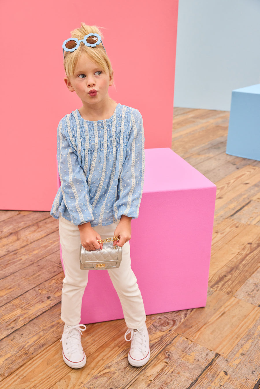 Model can be seen wearing a light blue shirt that features white dobby detailing and white lace stripes which pairs back perfectly with ivory jeans to complete the look. 