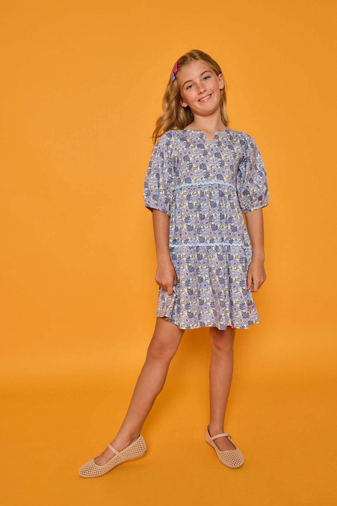 Model can be seen wearing blue floral corduroy dress with 3/4 sleeves and ric rac trim detail in light blue for an elevated look. 