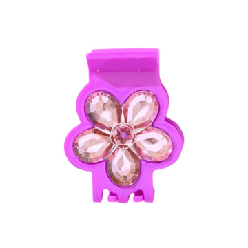 Pink flower hair clip against a white background