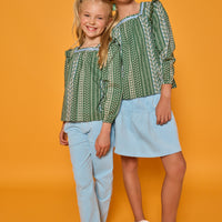 Models can be seen wearing woven long sleeved top with square neckline in a blue/white/green floral print. Paired back perfectly with the light blue corduroy pants or skort to complete the look. 