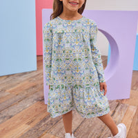 Model can be seen wearing woven long sleeve dress in a beautiful aqua/blue/green/yellow floral print.
