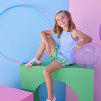 Tween model can be seen wearing a knit light blue halter tank top that features button closure along back and made of a soft comfy material. Top pairs back perfectly with woven shirred shorts in a beautiful green/light blue print to complete the look. 