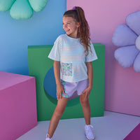 Model can be seen wearing pink and white stripe knit boxy tee that features a floral patch pocket that matches back perfectly with the aqua/purple floral trim on the track shorts to complete the look. 