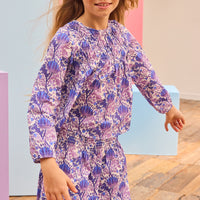 Tween model can be seen wearing purple/blue/white floral patterned top that has smocking/ruching across the bust for an elevated look which also pairs back perfectly with our skort in the same print. 