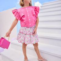 Model can be seen wearing hot pink woven top that features button closures down the front and big angel sleeve detail to elevate the look. Top pairs back perfectly with pink floral print on skort to complete the look.