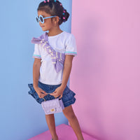 Model can be seen wearing a denim mini skirt that features ruffle detail and button closure for a secure fit. Pair skirt back with a ric rac tee to complete the look. 