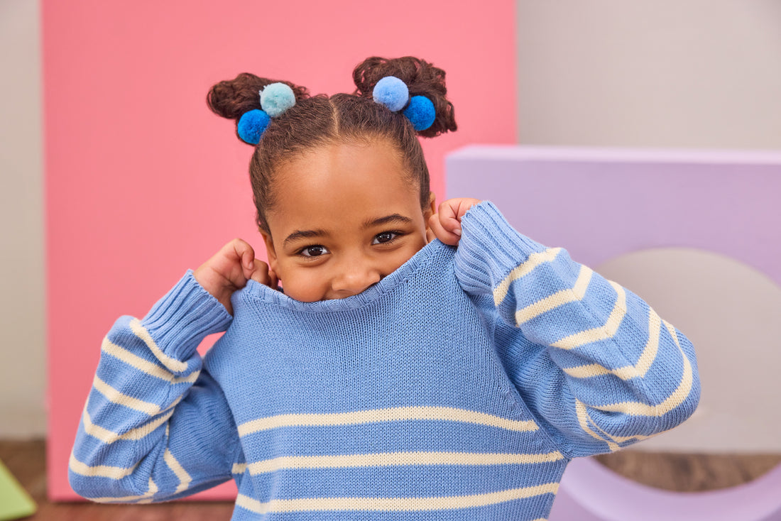Girl model can be seen wearing blue and white stripe sweater.