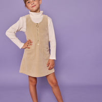 Model can be seen wearing oatmeal long sleeve ribbed knit top with paired underneath a stone corduroy jumper that features a quarter zip zipper and herringbone detail for an elevated look.