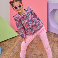 Model can be seen wearing bubblegum pink corduroy pants that feature a snap button closure and pockets in front and back for a secure but relaxed fit. Pair back pants with long sleeve woven top in pink/navy/cranberry floral top to complete the look.