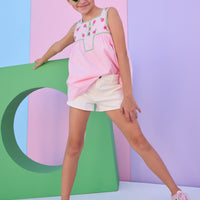 Model can be seen wearing ivory denim shorts that feature a snap button closure at waist, functioning zipper, and functioning pockets. Shorts pair back perfectly with any of our tops in the line to complete the look. 