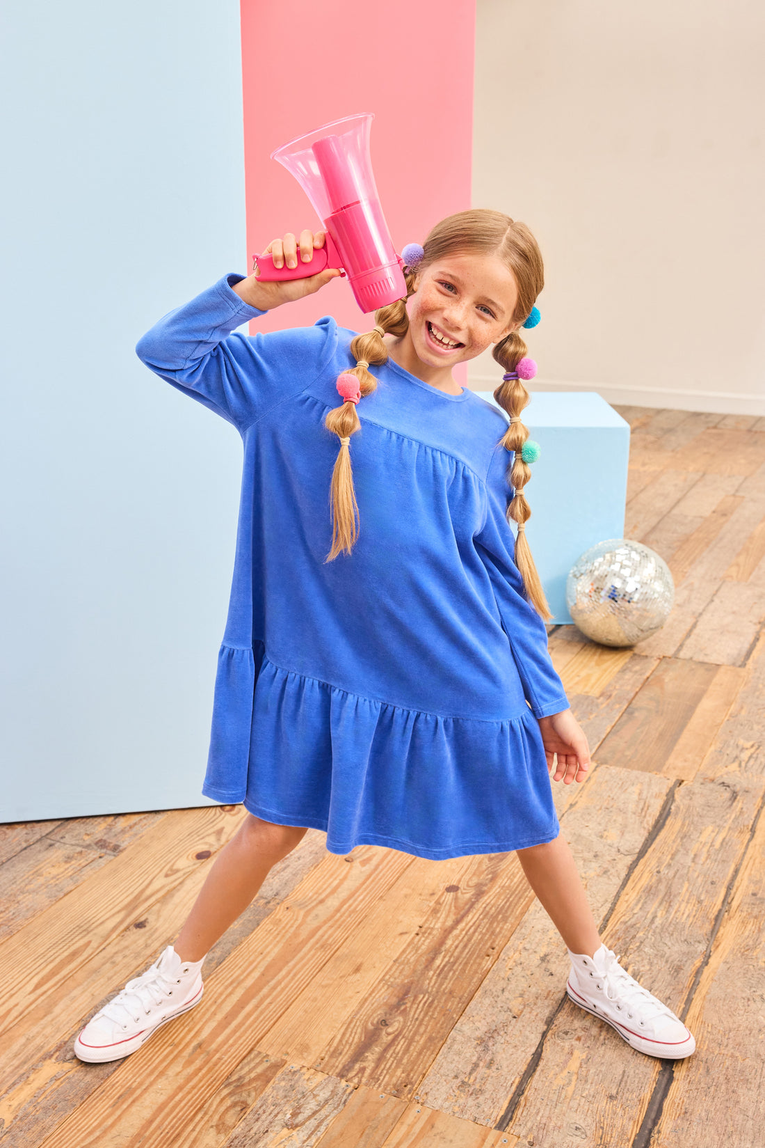 Model can be seen wearing a long sleeve royal blue velour dress which is made of a soft and stretchy velour and also features ruching along top tier and bottom tier of dress for an elevated look. 