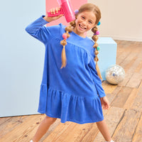 Model can be seen wearing a long sleeve royal blue velour dress which is made of a soft and stretchy velour and also features ruching along top tier and bottom tier of dress for an elevated look. 