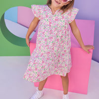 Model can be seen wearing a woven dress in a pink/green floral print. Dress features a slight v-neckline, angel sleeves, and button closure along back for a secure but comfy fit. 