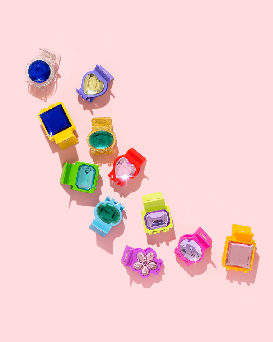 Colorful hair clips on a pink background