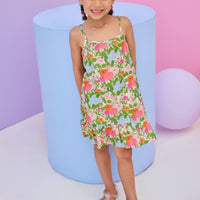 Model can be seen wearing woven strappy dress in a green/orange/pink/light blue floral print. Dress features button closures along back and made of a super soft woven material for a comfy but secure fit. 