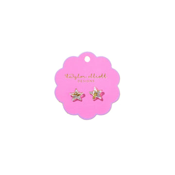 Star-shaped earrings on a pink card.