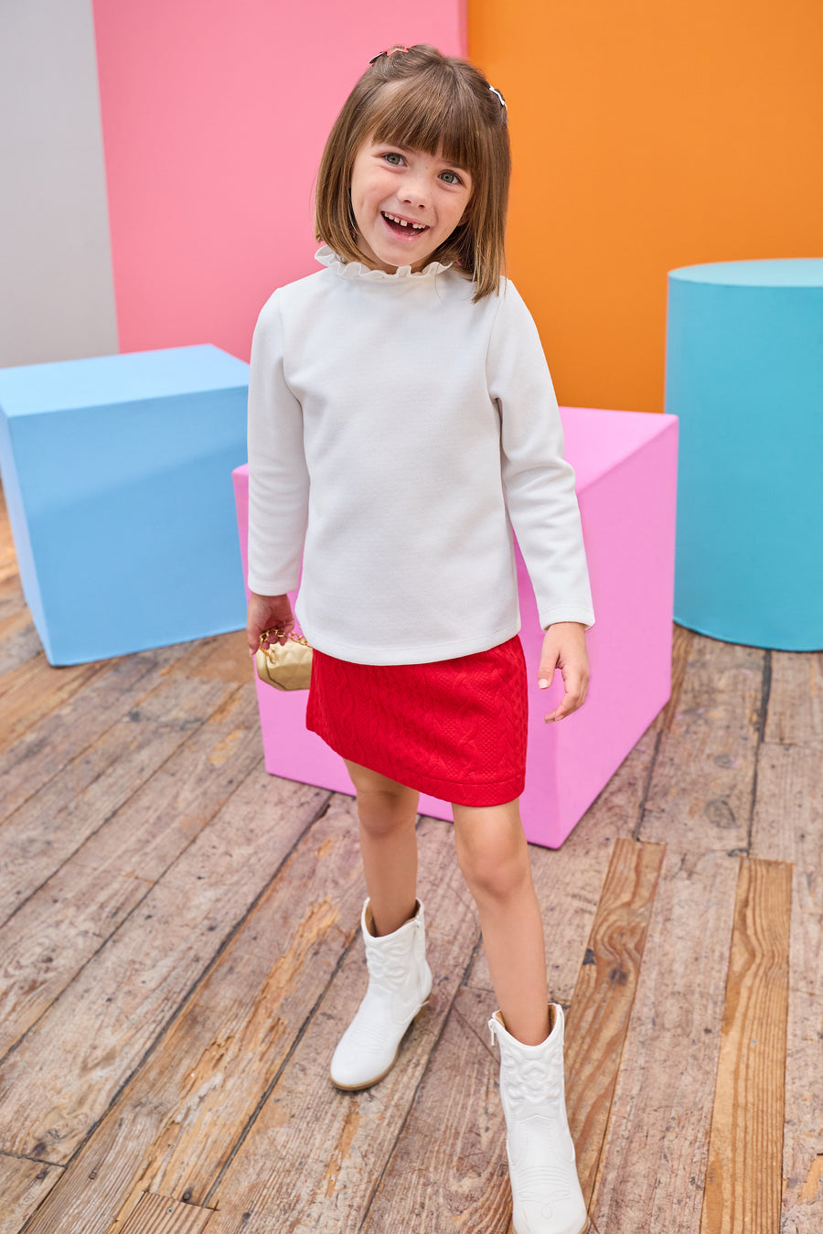 Model can be seen wearing a quilted knit mini skort that features an elastic waistband and built in shorts for a secure but relaxed fit. Pair back perfectly with a white long sleeve  knit top to complete the look. 