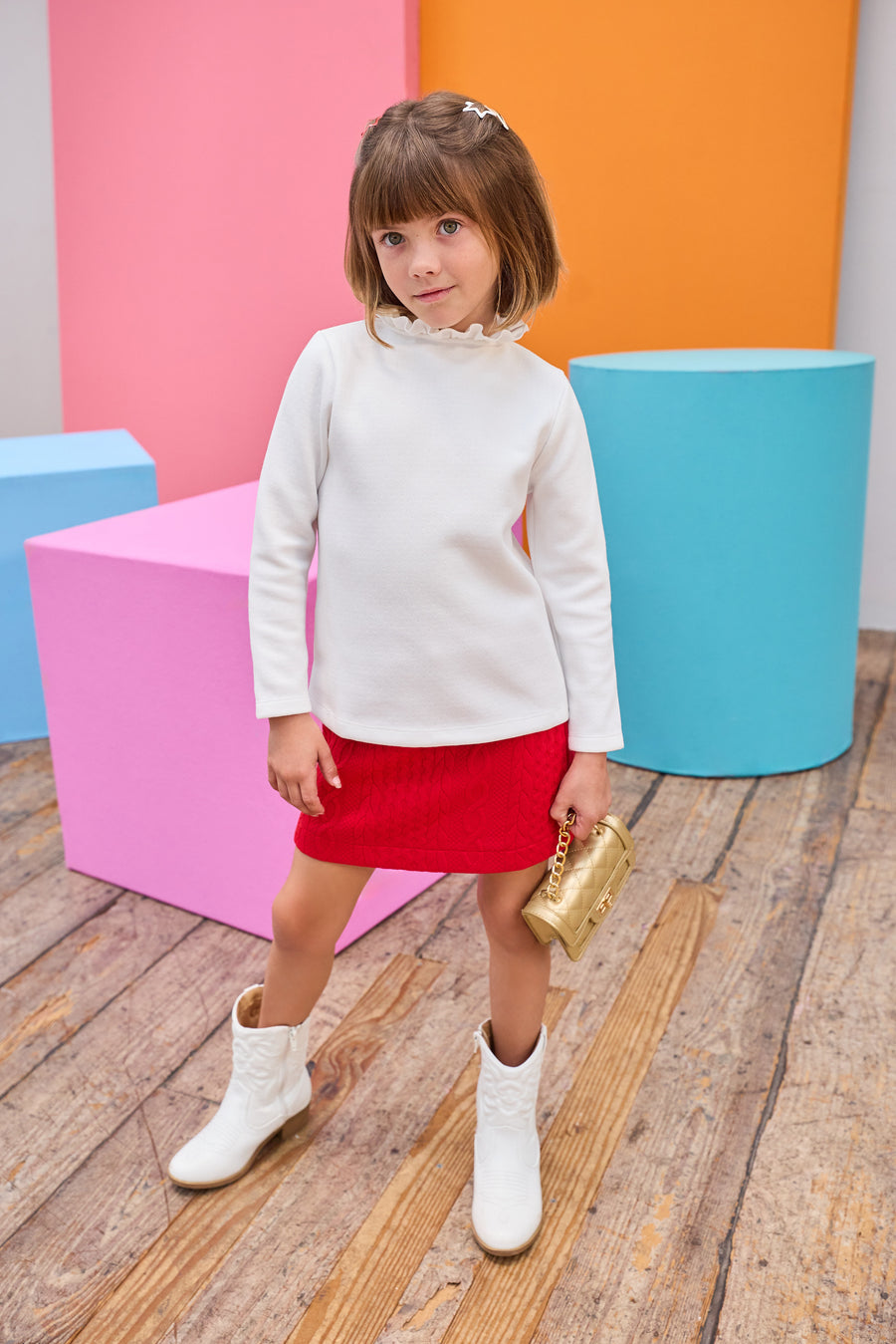 Model can be seen wearing a quilted knit mini skort that features an elastic waistband and built in shorts for a secure but relaxed fit. Pair back perfectly with a white long sleeve  knit top to complete the look. 