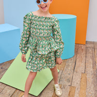 Model can be seen wearing two tiered woven skort in a green/blue/orange floral that features an elastic waistband and built in shorts for a relaxed but secure fit. Pair back the skort perfectly with the matching long sleeve woven top to complete the look. 