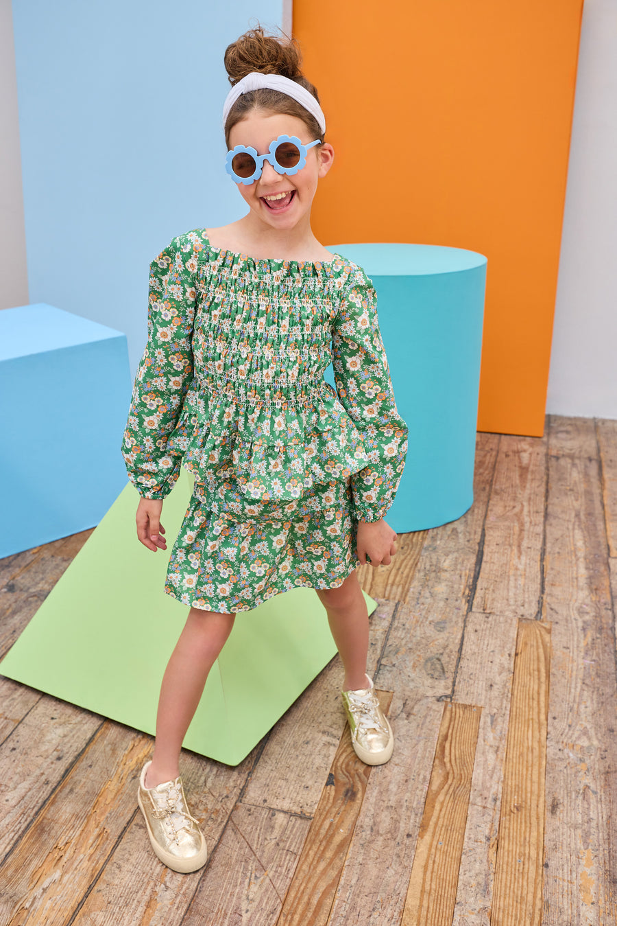 Model can be seen wearing two tiered woven skort in a green/blue/orange floral that features an elastic waistband and built in shorts for a relaxed but secure fit. Pair back the skort perfectly with the matching long sleeve woven top to complete the look. 
