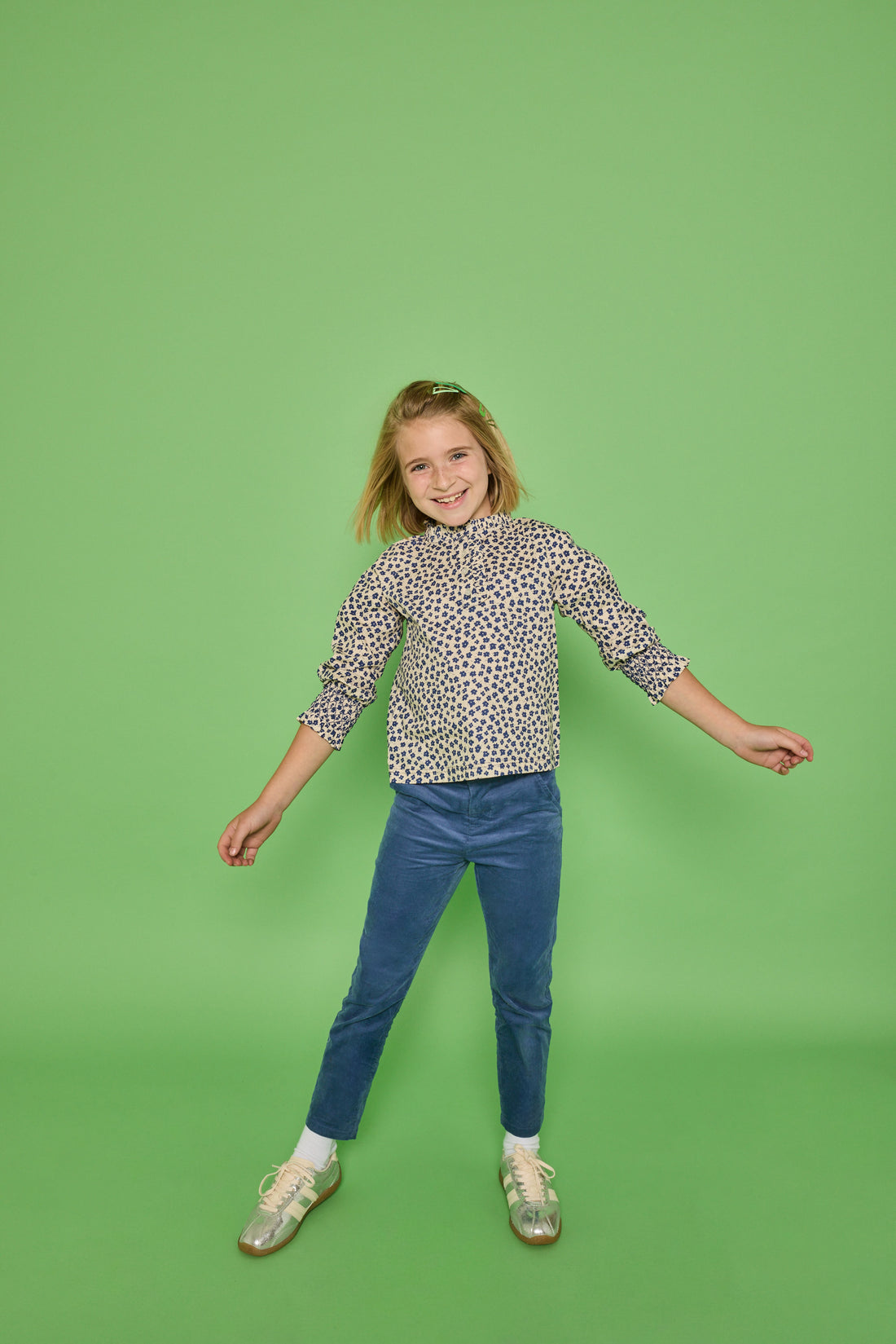 Model can be seen wearing a long sleeve woven top in a blue/cream floral print. Top features button closure packet down bust and smocking detail at sleeves for an elevated look. Paired back with our dusty blue corduroy pants to complete the look. 