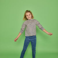 Model can be seen wearing a long sleeve woven top in a blue/cream floral print. Top features button closure packet down bust and smocking detail at sleeves for an elevated look. Paired back with our dusty blue corduroy pants to complete the look. 