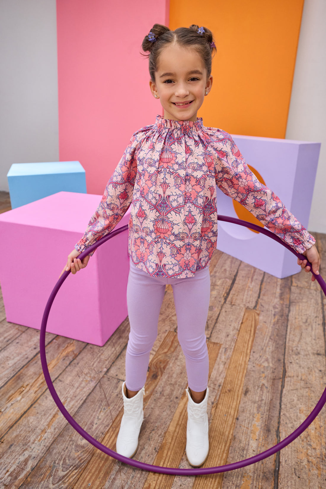 Tween model can be seen in a pink floral top paired back with our soft and stretchy lilac leggings. 