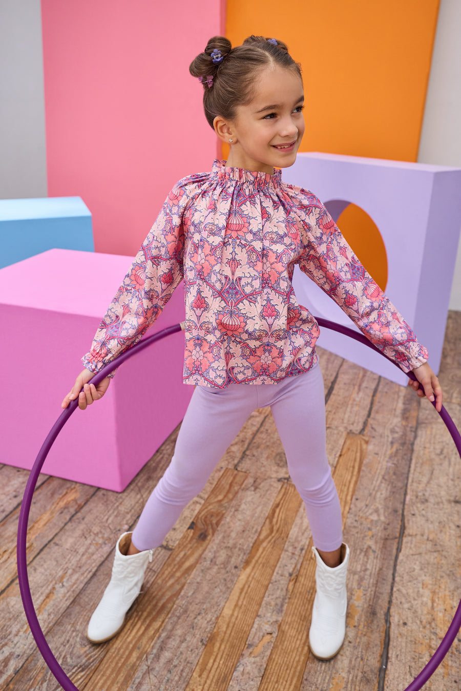 Tween model can be seen in a pink floral top paired back with our soft and stretchy lilac leggings. 
