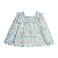 Woven long sleeve square neck top that features a light blue ribbon detail along neckline and elastic cuffs at sleeves for a relaxed but secure fit. Top is also seen to be in  a gorgeous blue/green/white floral pattern.