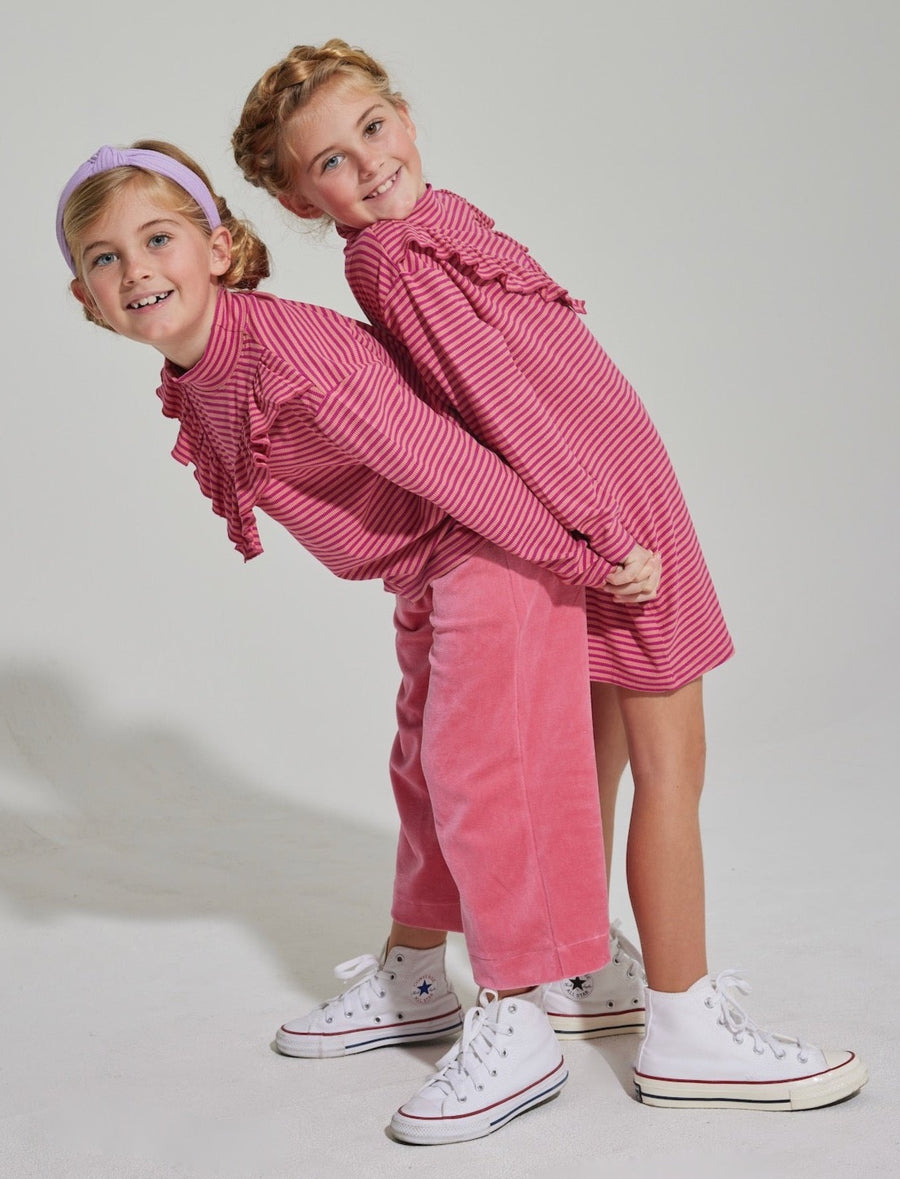 coordinating striped pink dress and matching skirt with pink velvet pants