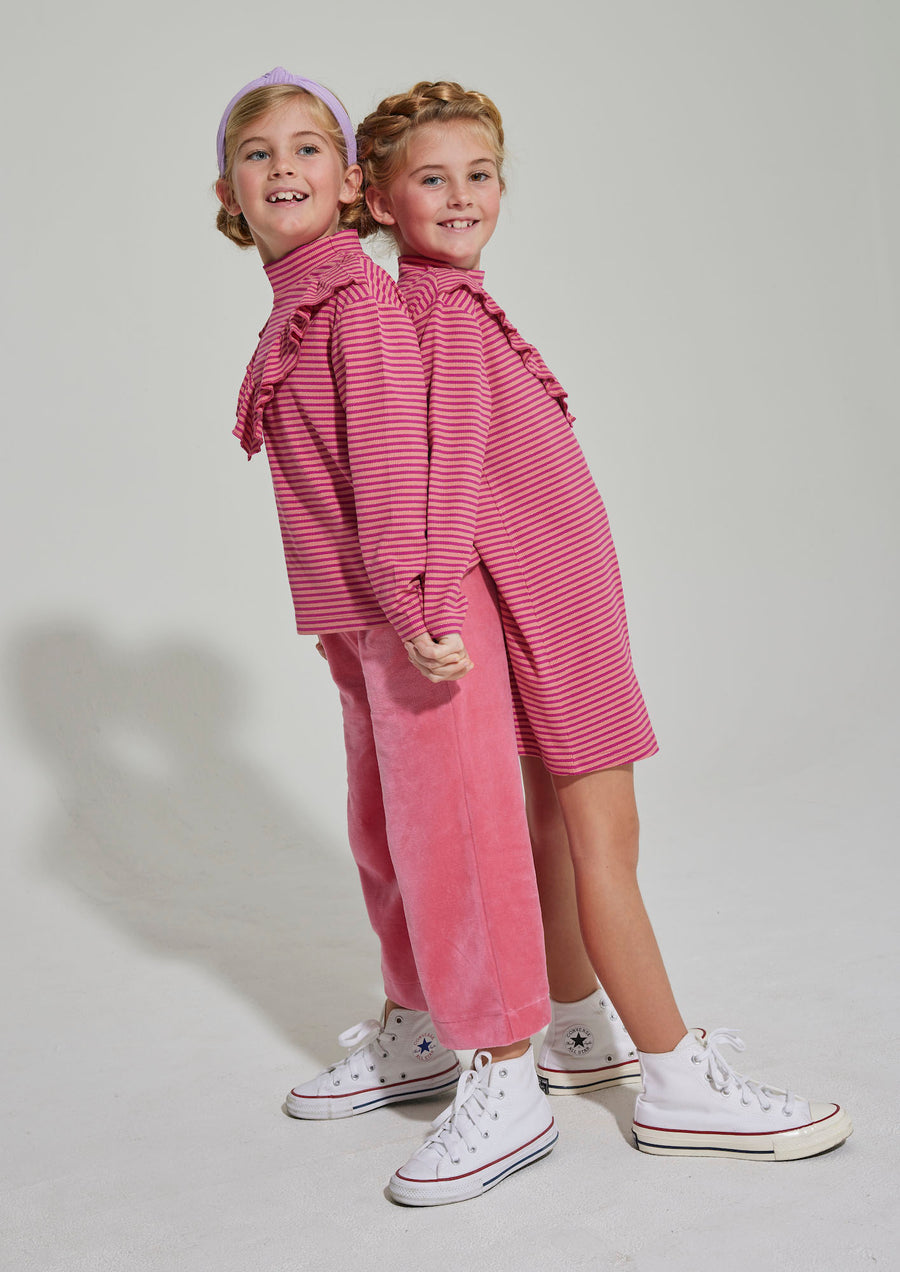 Our model on the right can be seen wearing our Aspen Dress in Cranberry Metallic Stripe and on the left you can see our Aspen Top in the same Cranberry Stripe--BISBY girl
