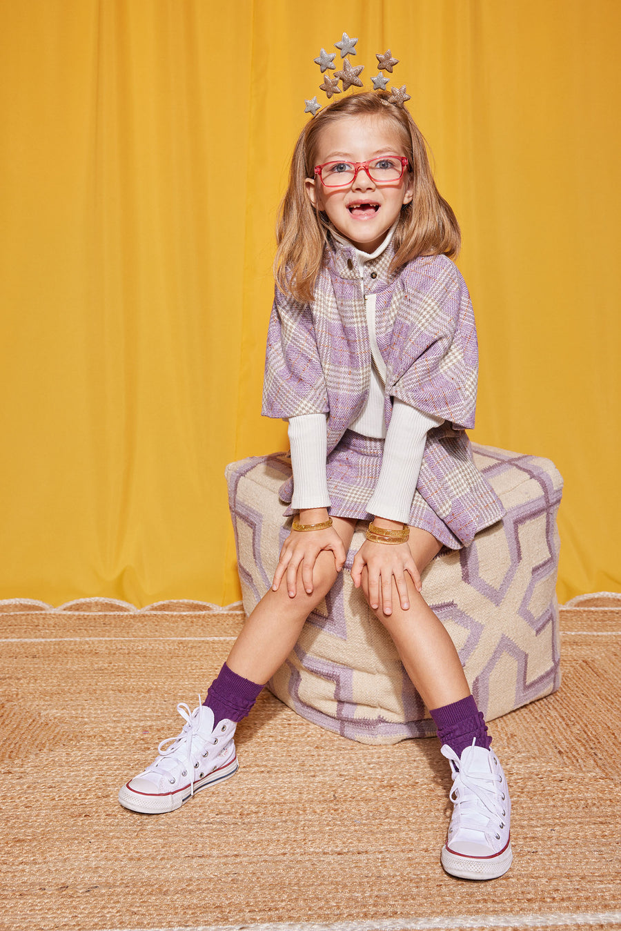 Model can be seen wearing our Mini Skirt in Lilac Tweed paired perfectly with our Cape in Lilac Tweed to complete the set. For layering, we have added our Ivory Ribbed Turtleneck underneath our Cape--BISBY girl 