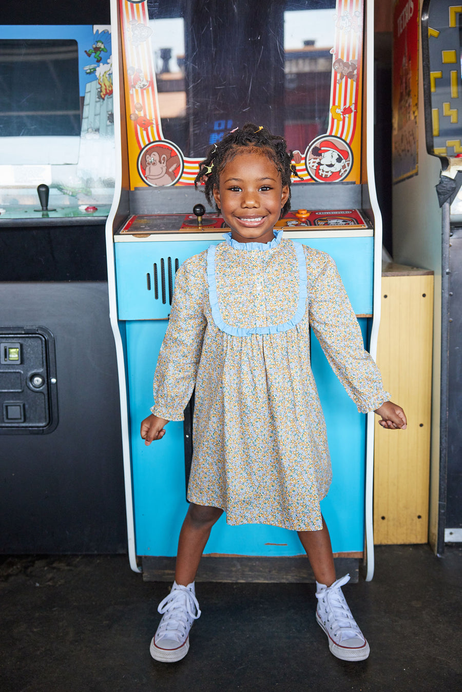 Little girl can be seen wearing our Chelsea Dress in our Devon Floral Amber-BISBY girl