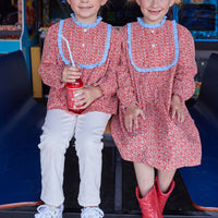 Girls can be seen wearing our Chelsea Top and Chelsea Dress in our Winterberry Red floral pattern. Pair our Chelsea Top with Twiggy Pants in Ivory for a complete look-BISBY GIRL