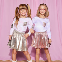 Girls can be seen wearing our Breton Tops in our Pink Stripe (left) and our Lilac Stripe (right). Easily pair these tops with our Circle Skirts in Gold and Pink Lame--BISBY girl