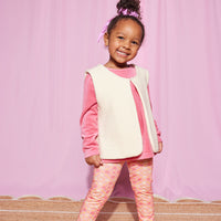 Little girl can be seen rocking our Lisle Top in Rose Velour with our Cream Sherpa Vest layered over it. She has completed the look with our Leggings in Seville Rose on the bottom--BISBY girl