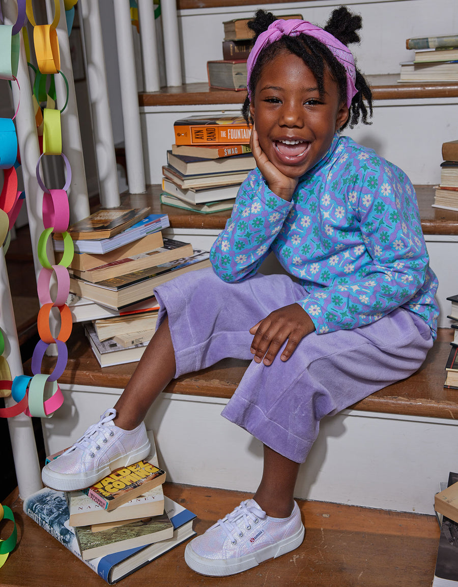 Little girl can be seen wearing our Seville Azul long sleeve turtleneck paired with our Lilac Cropped Velour Palazzo Pant--BISBY girl