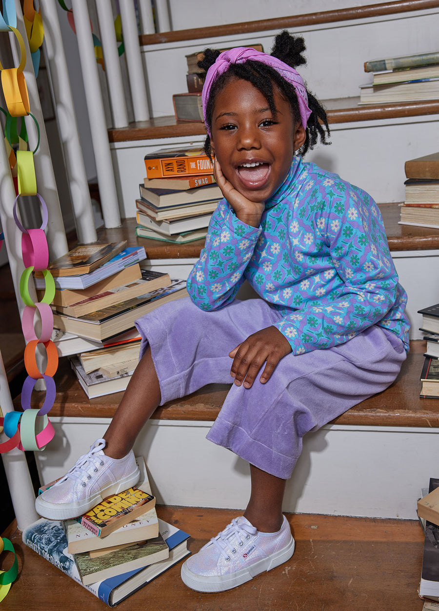 Little girl can be seen wearing our Seville Azul long sleeve turtleneck paired with our Lilac Cropped Velour Palazzo Pant--BISBY girl