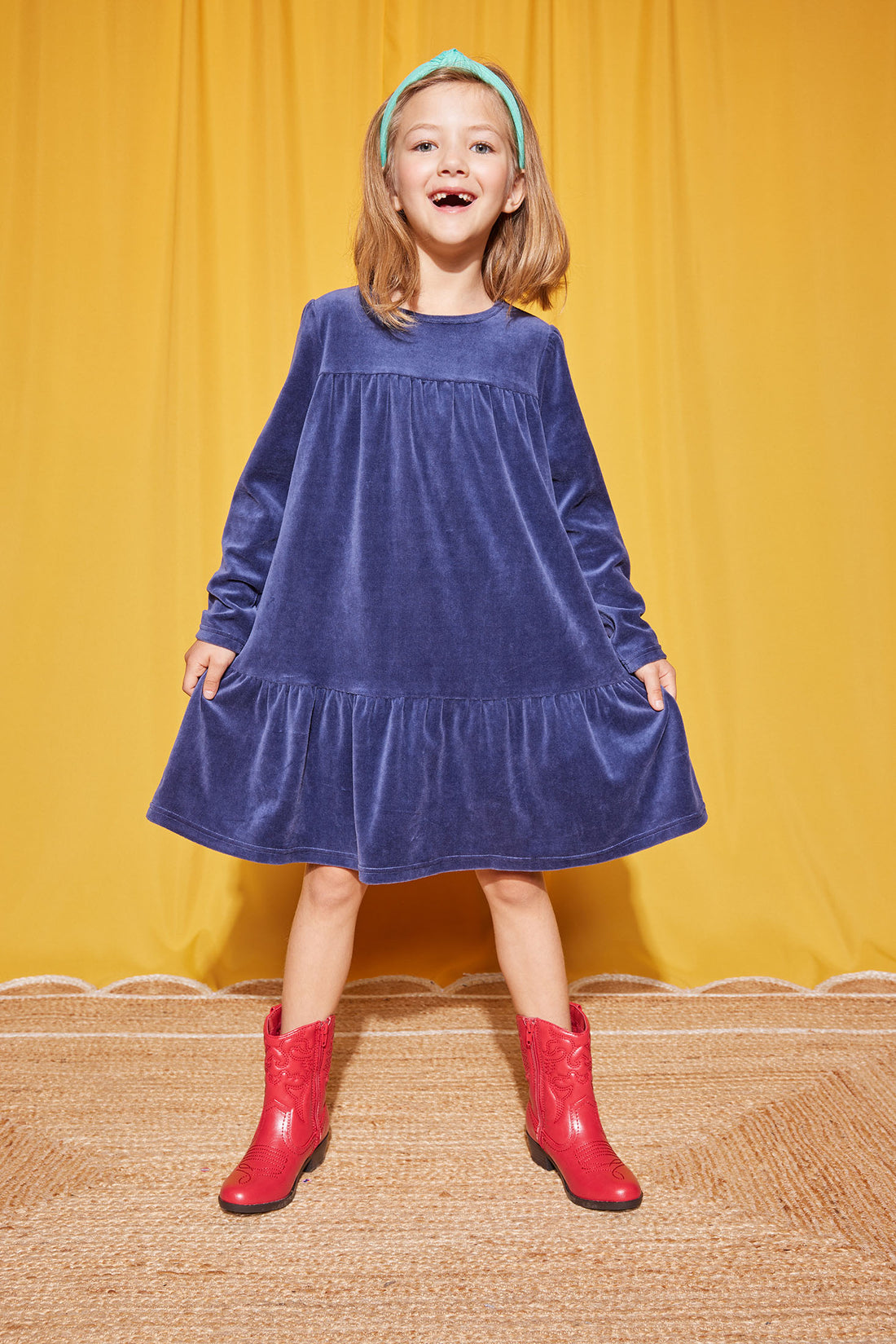 Our model can be seen wearing our Lisle Dress in our Navy Velour color--BISBY girl