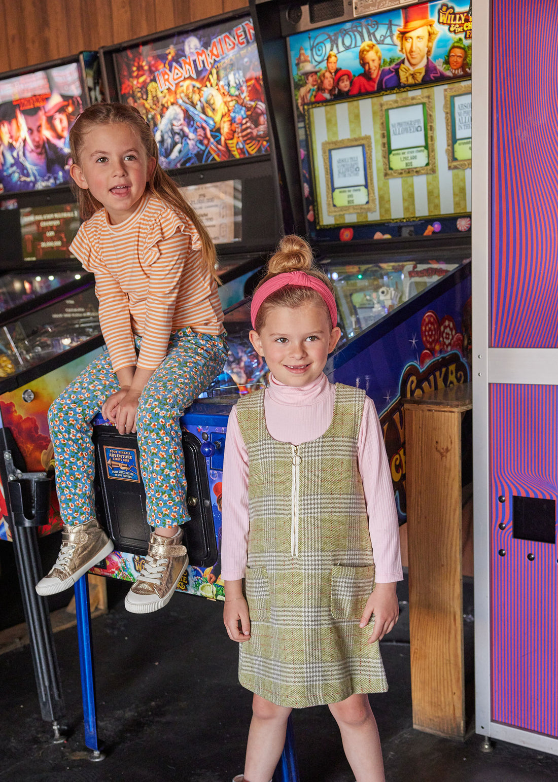 Girl on the right canoe seen wearing our Retro Jumper in Sage Tweed with our Pink Ribbed Turtleneck underneath. Our model on the left can be seen wearing our Sadie Top in Orange Sparkle Stripe paired with our Blue Floral Corduroy Twiggy Pants--BISBY Girl