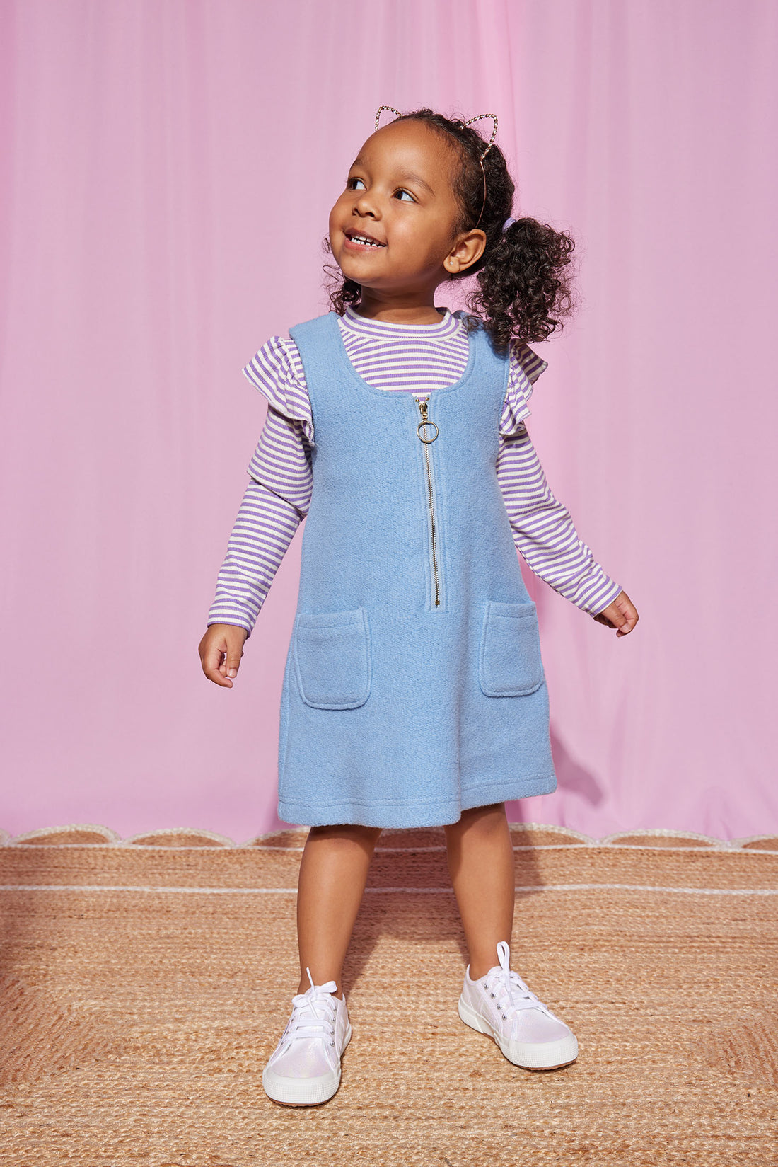 Our little model can be seen wearing our Retro Sherpa Jumper in Light blue with our Sadie Top in Lilac Sparkle Stripe layered underneath-BISBY girl