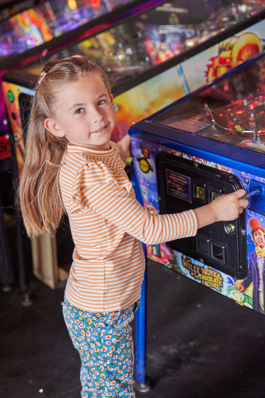 Little girl can be seen rocking our Blue Floral Corduroy Twiggy Cords paired with our Orange Sparkle Stripe shirt--BISBY girl