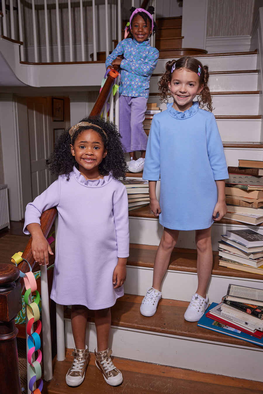 Our models in the front can be seen rocking our Tory Dresses with the ruffled neckline  in Lilac and Light Blue. Our model in the back can be seen wearing our Seville Azul Turtleneck paired with our Cropped Palazzo Pants in Lilac Velour--BISBY girl