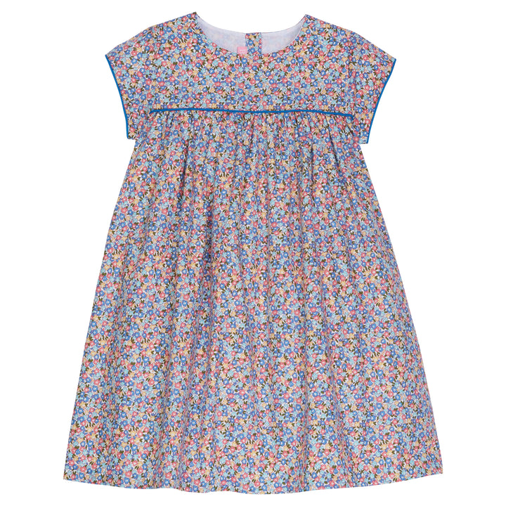 Our Charlotte dress in Devon Floral Blue details a beautiful mix of red, yellow., and blue flowers. There is a solid blue trim around the arms and across bust adding a more structured look--BISBY girl