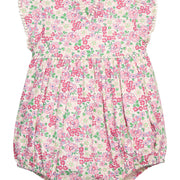 BISBY baby knit bubble in a pink/green floral print. Bubble features button closure along back and stride, white pom pom detail across the middle/bust area, and white pom pom detail along sleeve cuffs for an elevated look.