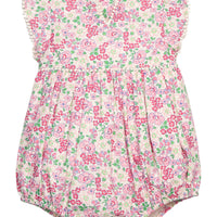 BISBY baby knit bubble in a pink/green floral print. Bubble features button closure along back and stride, white pom pom detail across the middle/bust area, and white pom pom detail along sleeve cuffs for an elevated look.